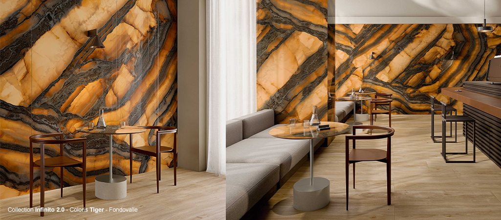 Revêtement mural en grès cérame effet marbre Tiger de la collection Infinito 2.0 par Fondovalle dans un café moderne.